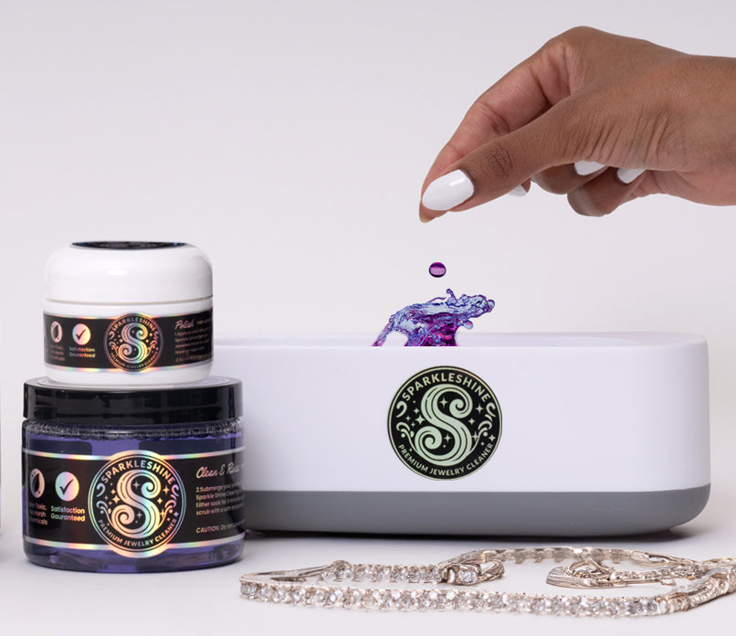 Using Sparkle Shine ultrasonic jewelry cleaner — dropping cleaning solution into machine with jewelry beside it